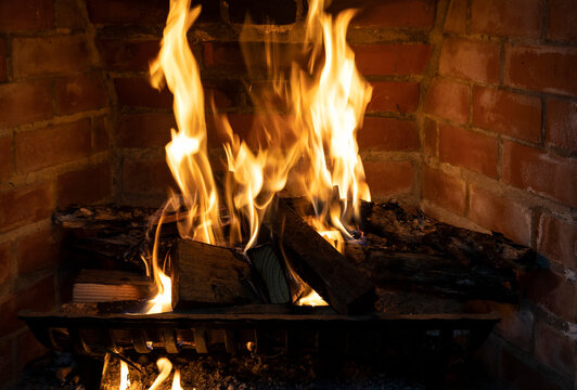 Close up view of a fireplace fire burning