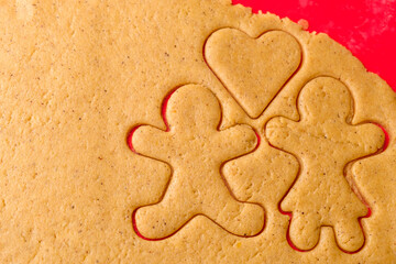 Cutting gingerbread shapes. Family or love couple concept from dough for St. Valentines Day. 