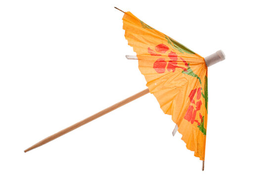Summer party and drinking glass decoration concept with picture of colourful orange cocktail paper decorative umbrella isolated on white background with clipping path cutout