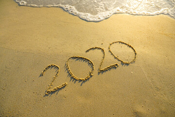 Year 2020 inscription written on the sandy beach. New year conceptual.