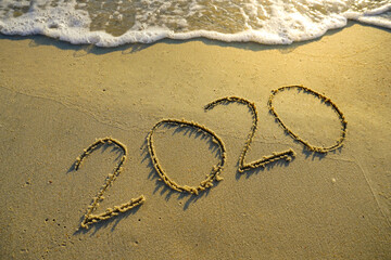 Year 2020 inscription written on the sandy beach. New year conceptual.