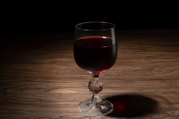 Glass of wine on a dark wooden table