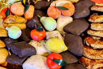 Assortment of Italian pastries ready to be enjoyed. Neapolitan mostaccioli and fruit with almond paste