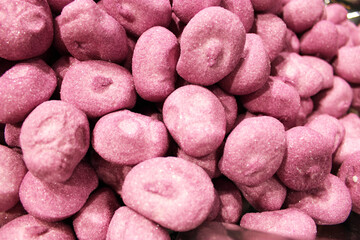 Candy A lot of sweets. Colorful texture using a background. Background rendering. Bright multiple jelly candies in powdered sugar. Confectionery wallpaper concept. Copy space. Shallow focus. Close-up