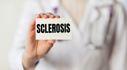 SCLEROSIS. Card with text in hand of Medical Doctor.