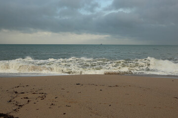 Waves sweeping against the rocks and the beach