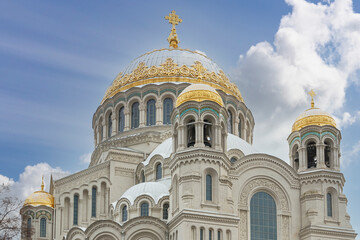 Front view of the facade of the Naval Cathedral in Kronstadt, Russia against a blue autumn sky