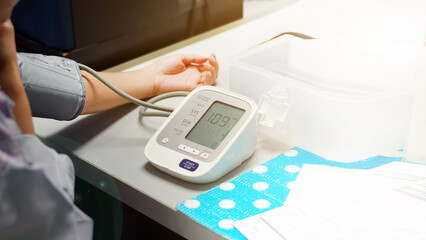 Check women's health,and heart rate with digital pressure gauge standard blood pressure test results .Health and Medical concept.                              