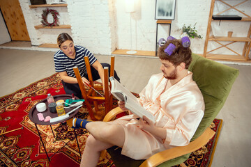 Gender stereotypes. Wife and husband doing things unusual for their genders in social meanings,...