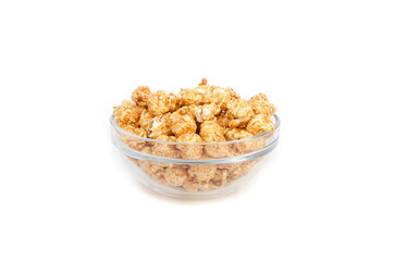 Caramel popcorn in a glass bowl on a white background