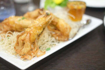 Crispy fried prawn with garlic and pepper in white plate