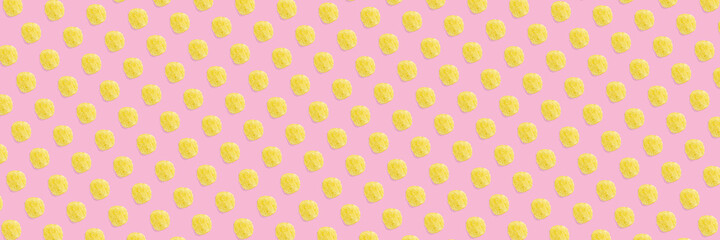 background made from Potato chips on pink background flat lay. potato snack chips isolated Fast food banner.