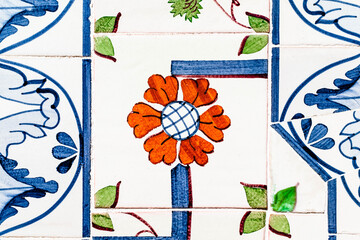 Portuguese traditional tiles Azulejos with colorful floral pattern on a white background.