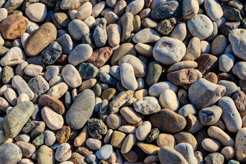 Smooth round pebbles texture background. Pebble sea beach close-up