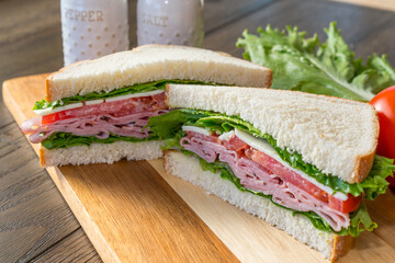 Ham and cheese sandwhich on cutting board
