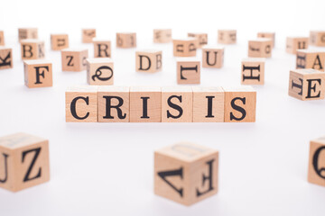 Crisis concept. Close up view photo of wooden blocks making word crisis isolated white backdrop table