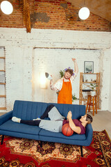 Gender stereotypes. Wife and husband doing things unusual for their genders in social meanings,...