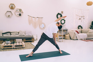 Man doing yoga exercise during Xmas holidays