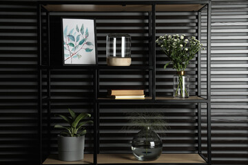 Decorative vases with plants on shelving unit indoors