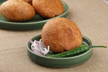 Indian teatime snack called Kachori or kachodi served with mint and tamarind dip or chutney. This is a popular in North and Central India