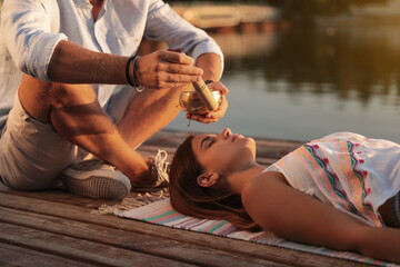 Woman at healing session with singing bowl outdoors