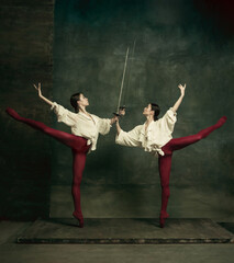 Fight. Two young female ballet dancers like duelists with swords on dark green background....