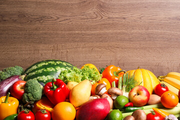 Assortment of fresh organic fruits and vegetables on wooden background, closeup. Space for text