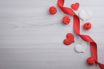 Background for Valentine's Day greeting card.Valentines day concept.Red gift ribbons, gifts, hearts on a wooden background. Top view