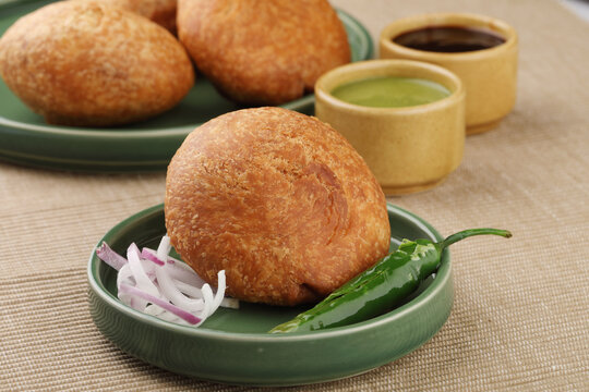 Indian teatime snack called Kachori or kachodi served with mint and tamarind dip or chutney. This is a popular in North and Central India