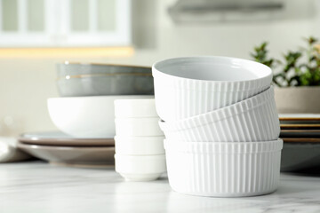 Fototapeta na wymiar Set of beautiful tableware on white table in kitchen