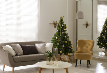 Beautiful Christmas tree and sofa in contemporary living room. Interior design
