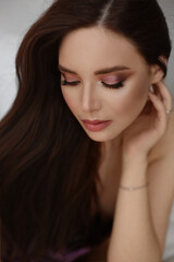Obraz premium Beautiful portrait of European young model woman with perfect evening makeup and beautiful long healthy hair