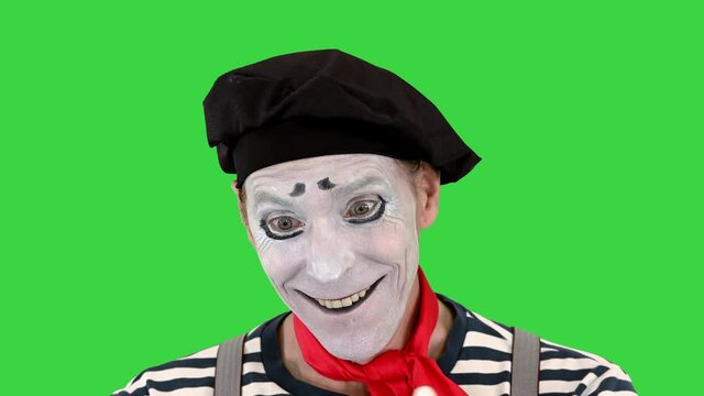 Mime in white gloves performs something on a Green Screen, Chroma Key.