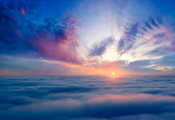 Naklejka na ściany i meble Dawn or sunset over the clouds, blue hour, aerial view.