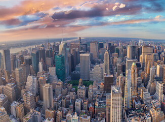 NEW YORK CITY - JUNE 10, 2013: Panoramic aerial view of Manhattan from a city rooftop at sunset