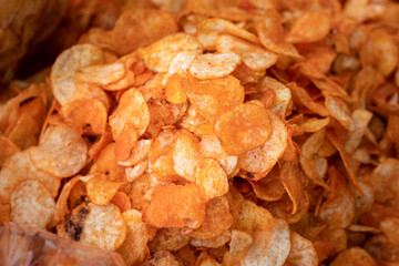 Fried sliced potato with BBQ taste snack crisp which is selling in local market. Food and texture photo. 