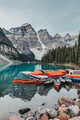 Canoes on a jetty on the turquoise waters of Moraine Lake, located in Banff National Park, Alberta, Canada, situated in the Valley of the Ten Peaks. The peaks are known as the "Twenty Dollar View".