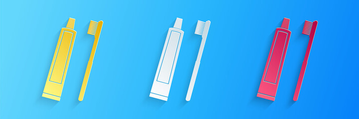 Paper cut Tube of toothpaste and toothbrush icon isolated on blue background. Paper art style. Vector.