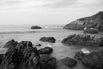 rocky coast of the indian ocean in black and white