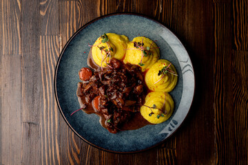 Top view of austrian goulash on a dark wooden table