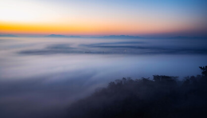 Fototapeta na wymiar The sea of mist in the winter morning covers the village below in Li District, Lamphun Province, Thailand.