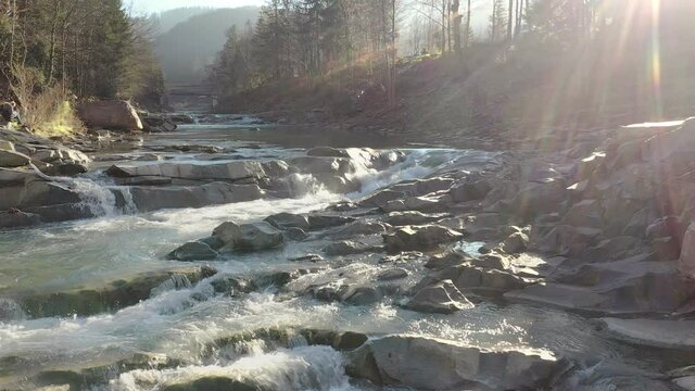 Wild mountain river flowing with stone boulders and stone rapids. Probiy river in the Carpathians, Ukraine