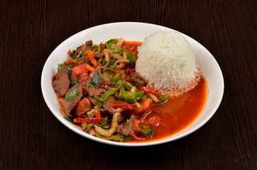 stewed beef with vegetables and rice in sauce. table setting, restaurant, asian cuisine