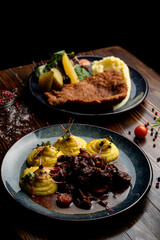 Austrian meals on dark wooden table, top view