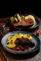 Austrian meals on dark wooden table, top view