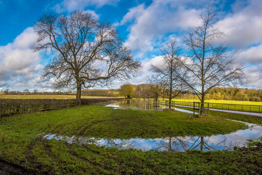 A view down a flooded lane near to Pitsford Reservoir, UK on a sunny day