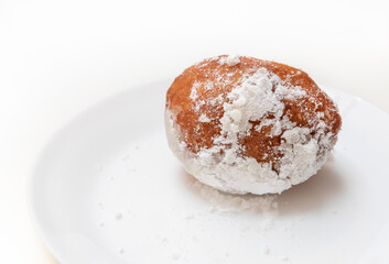 Dish with oliebollen, traditional Dutch pastry for New Year's Eve isolated on white background, pastry, oil dumpling or fritter