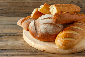 Types of homemade bread on the rustic wooden table. Homemade baked pastry.