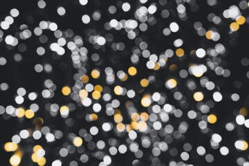 Christmas lights. Festive New Year blurred gray, yellow and black background. Banner. Beautiful sparkling backdrop, texture. Bokeh. Copy space. Place for text. Template. Trendy shades. Xmas.