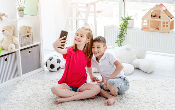 Happy Boy And Girl Taking Selfie